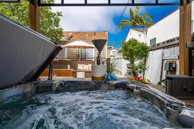 a swimming pool with a water slide in a backyard at PB Compound Getaway Steps to Surf and Sand in San Diego