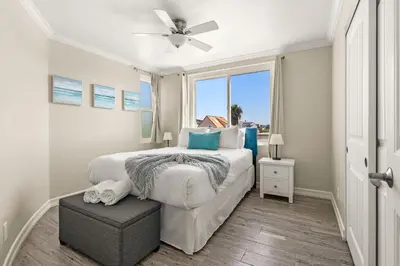 a white bedroom with a bed and a window at Mission Beach Marvel in San Diego