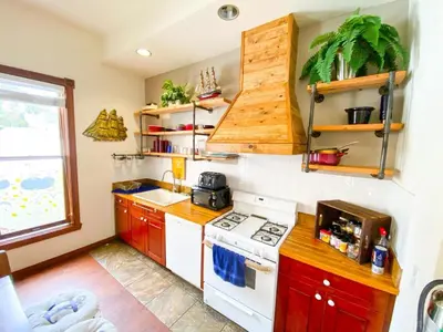 a small kitchen with a white stove top oven at International Travelers House Downtown San Diego - Adults Only in San Diego