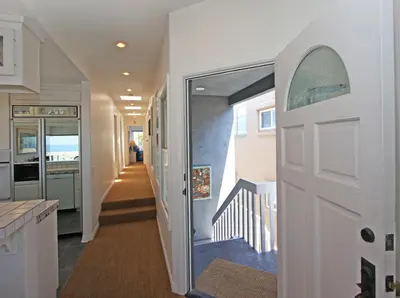 a hallway with a door leading to a staircase at 1023 E Balboa B in Newport Beach