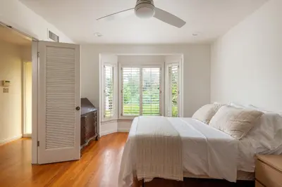 a white bedroom with a bed and a ceiling fan at La Jolla Shores Family Getaway in San Diego