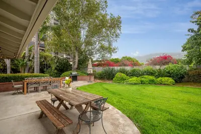 a patio with a picnic table and a green lawn at La Jolla Shores Family Getaway in San Diego