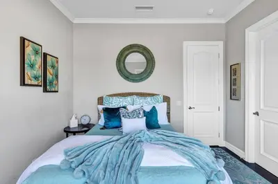 a bedroom with a large bed with blue pillows at Luxurious Mansion in Wine Country in Temecula