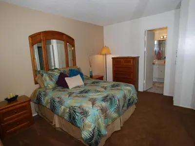 a bedroom with a bed and a dresser and a lamp at 3 Bedrooms in Newport Beach