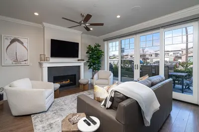 a living room with a couch and a fireplace at 1225 W Balboa Blvd A in Newport Beach