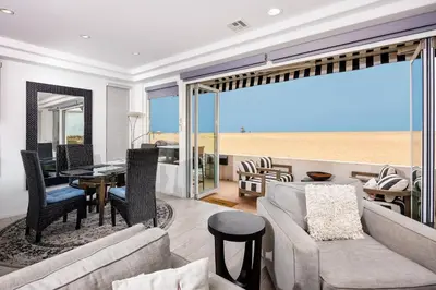 a living room with a couch and a dining room at 204 E Oceanfront A in Newport Beach
