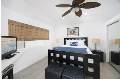 a bedroom with a bed and a ceiling fan at 204 E Oceanfront A in Newport Beach