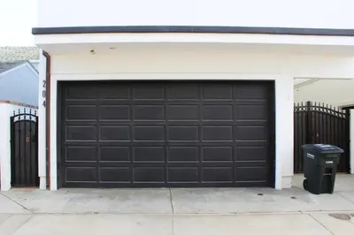 a garage with a black garage door on a house at 204 E Oceanfront A in Newport Beach