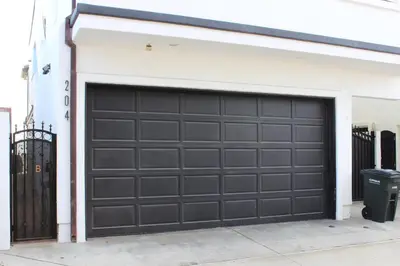 a garage with a black garage door on a house at 204 E Oceanfront A in Newport Beach