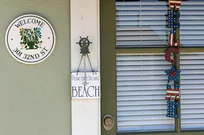 a house with a sign on the side of a window at Lower West Newport in Newport Beach