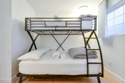 a bunk bed with towels on it in a room at Christina - Beachfront in Newport Beach