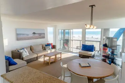 a living room with a couch and a table at Christina - Beachfront in Newport Beach