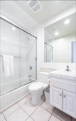 a bathroom with a toilet and a shower and a sink at Christina - Beachfront in Newport Beach