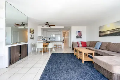 a living room with a couch and a table at Christina - Beachfront in Newport Beach