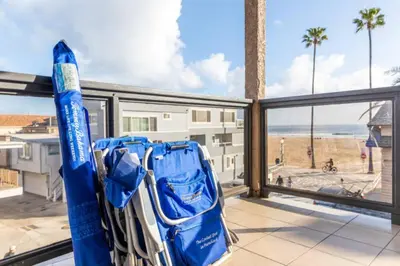 a room with a view of the ocean from a balcony at Alexander - Oceanview in Newport Beach