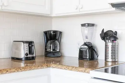 a kitchen counter with appliances on a counter top at Christopher - Oceanview in Newport Beach