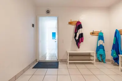 a hallway with a door to a bathroom with towels at Christopher - Oceanview in Newport Beach