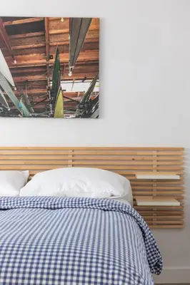 a bedroom with a bed with a blue and white blanket at Christopher - Oceanview in Newport Beach