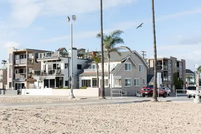 a street with houses and palm trees on a beach at Daniel - Oceanview in Newport Beach