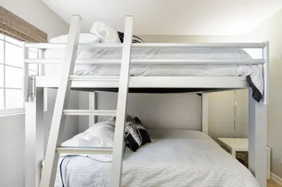 a bedroom with bunk beds in a dorm room at Beachfront Home in Newport Beach