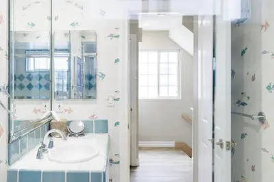 a bathroom with a sink and a mirror at Beachfront Home in Newport Beach