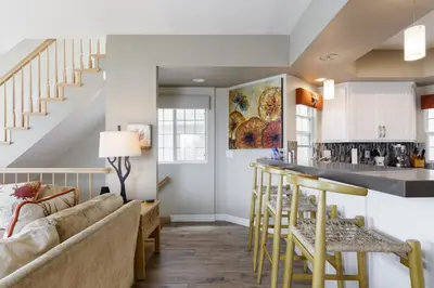 a kitchen and living room with a couch and a bar at Beachfront Home in Newport Beach
