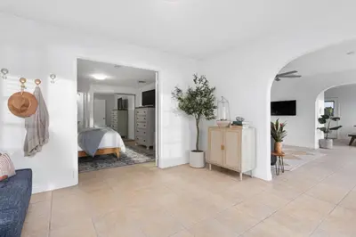 a bedroom with a bed and a living room at The Pelican in Encinitas
