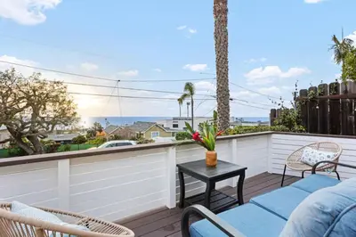a patio with chairs and a table on a balcony at The Pelican in Encinitas