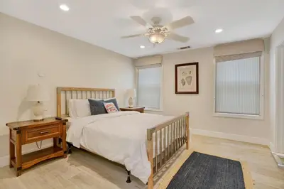 a bedroom with a bed and a ceiling fan at 3312 W Oceanfront in Newport Beach