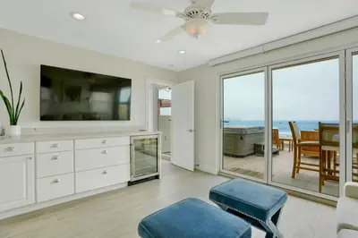 a living room with a view of the ocean at 3312 W Oceanfront in Newport Beach