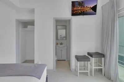 a bedroom with a bed and a table and two stools at The Shining Sea Crab in Oceanside