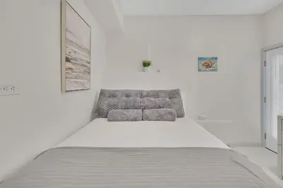a white bedroom with a large bed in it at The Shining Sea Octopus in Oceanside