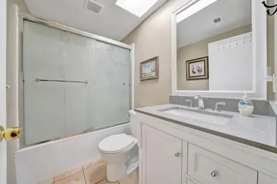 a bathroom with a sink and a toilet and a shower at 3607 Seashore Dr A in Newport Beach