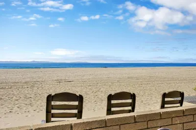 two chairs sitting in the sand on a beach at 3607 Seashore Dr A in Newport Beach