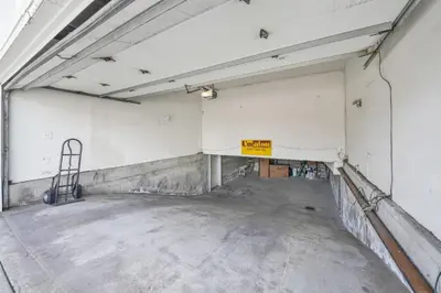 an empty parking garage with a sign on the wall at 3607 Seashore Dr A in Newport Beach