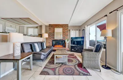 a living room with a couch and a fireplace at 3607 Seashore Dr A in Newport Beach