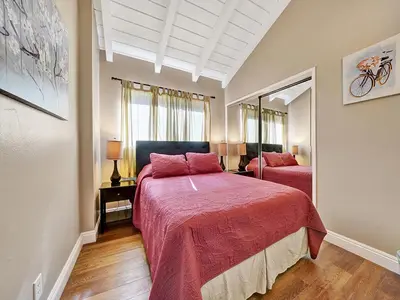 a bedroom with two beds with red sheets at 3607 Seashore Dr B in Newport Beach