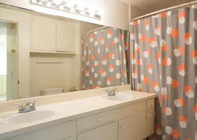 a bathroom with two sinks and a shower curtain at 3610 Seashore Dr in Newport Beach