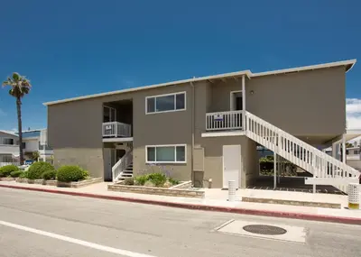a apartment building with stairs and a street at 3610 Seashore Dr in Newport Beach