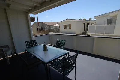 a patio with a table and chairs on a balcony at 4210 Seashore Dr in Newport Beach