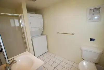a white bathroom with a toilet and a sink at 4212 Seashore Dr A in Newport Beach