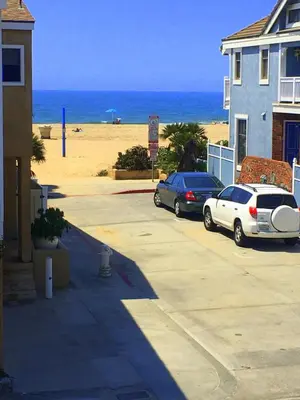 two cars parked in a parking lot next to a beach at 4212 Seashore Dr A in Newport Beach