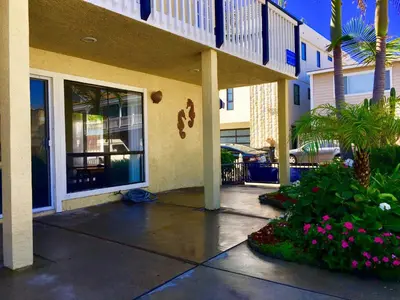 a front porch of a building with pink flowers at 4212 Seashore Dr A in Newport Beach