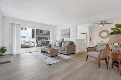 a living room with a couch and a table at 5408 Seashore Dr A in Newport Beach
