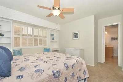a bedroom with a bed with a ceiling fan at 925 W Bay Ave in Newport Beach