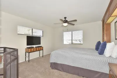 a bedroom with a bed and a ceiling fan at 925 W Bay Ave in Newport Beach