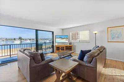 a living room with two couches and a large window at 925 W Bay Ave in Newport Beach