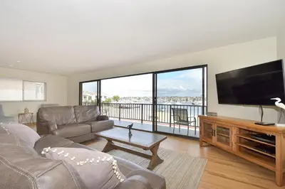 a living room with a large flat screen tv at 925 W Bay Ave in Newport Beach