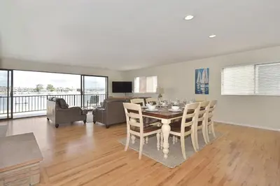 a dining room with a table and chairs and a living room at 925 W Bay Ave in Newport Beach
