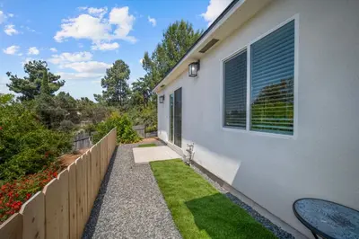 a house with a fence and a yard with grass at Modern Oasis New 2BR in La Mesa in La Mesa
